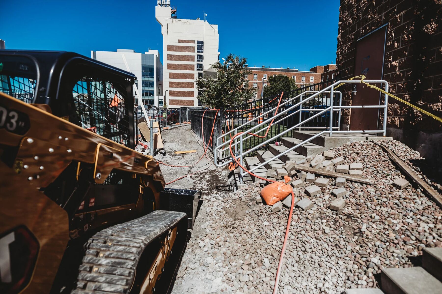 Rail and roadway work in progress alongside a fenced work zone