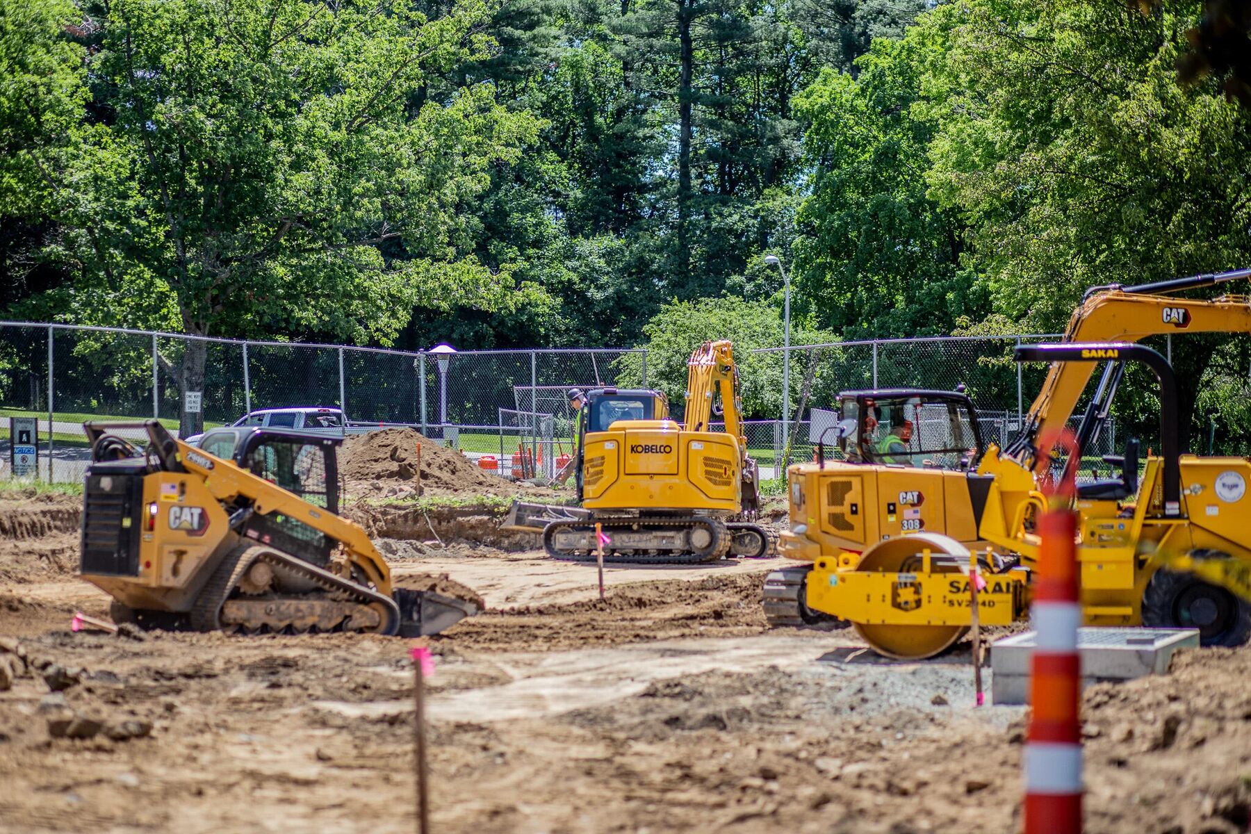 A compact track loader moving material on a federal campus