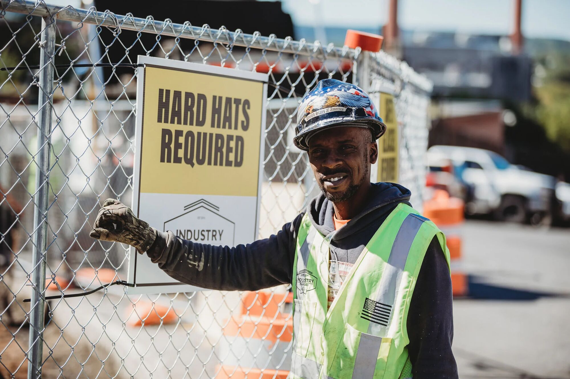 A hard hats required sign at the entrance to an Industry Standard USA work zone