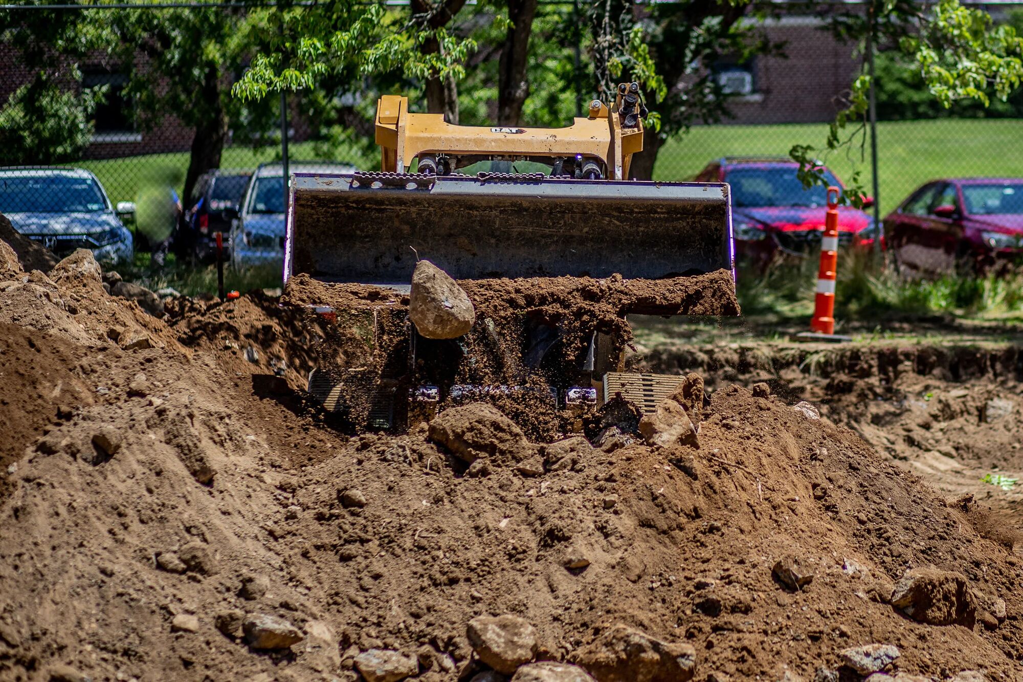 A dozer pushing spoil across a stockpile at an excavation site