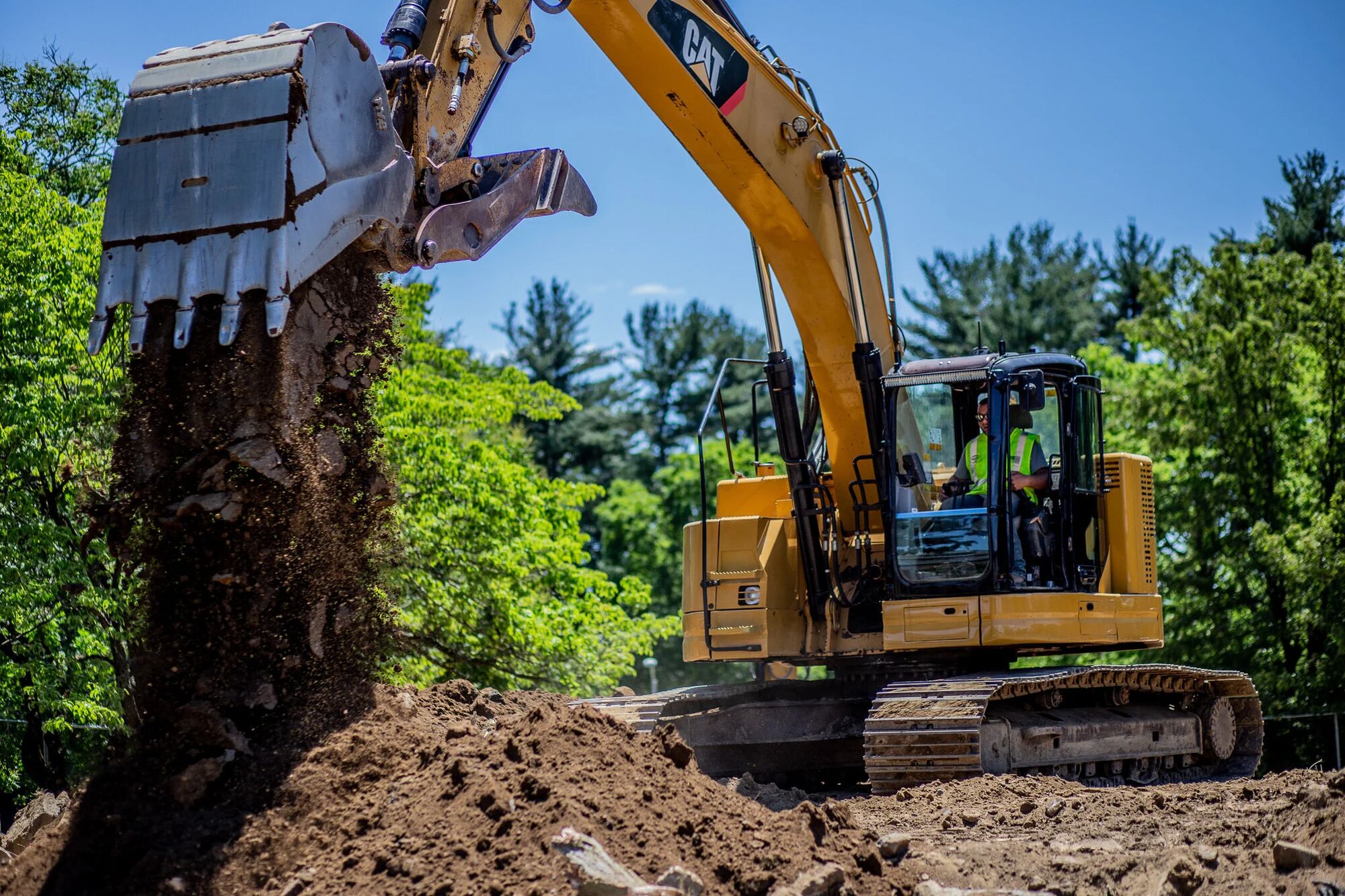 An excavator loading a haul truck at an active Industry Standard USA jobsite