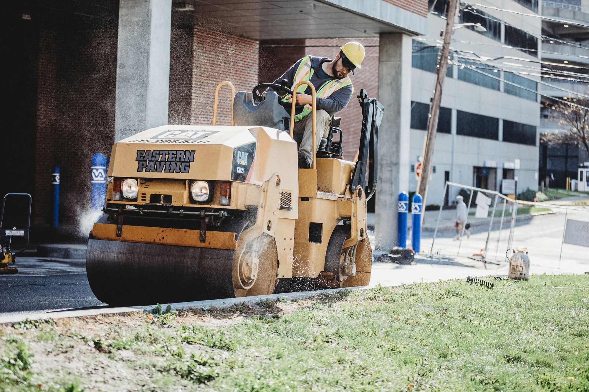Industry Standard USA equipment finishing a roadway surface on a federal campus